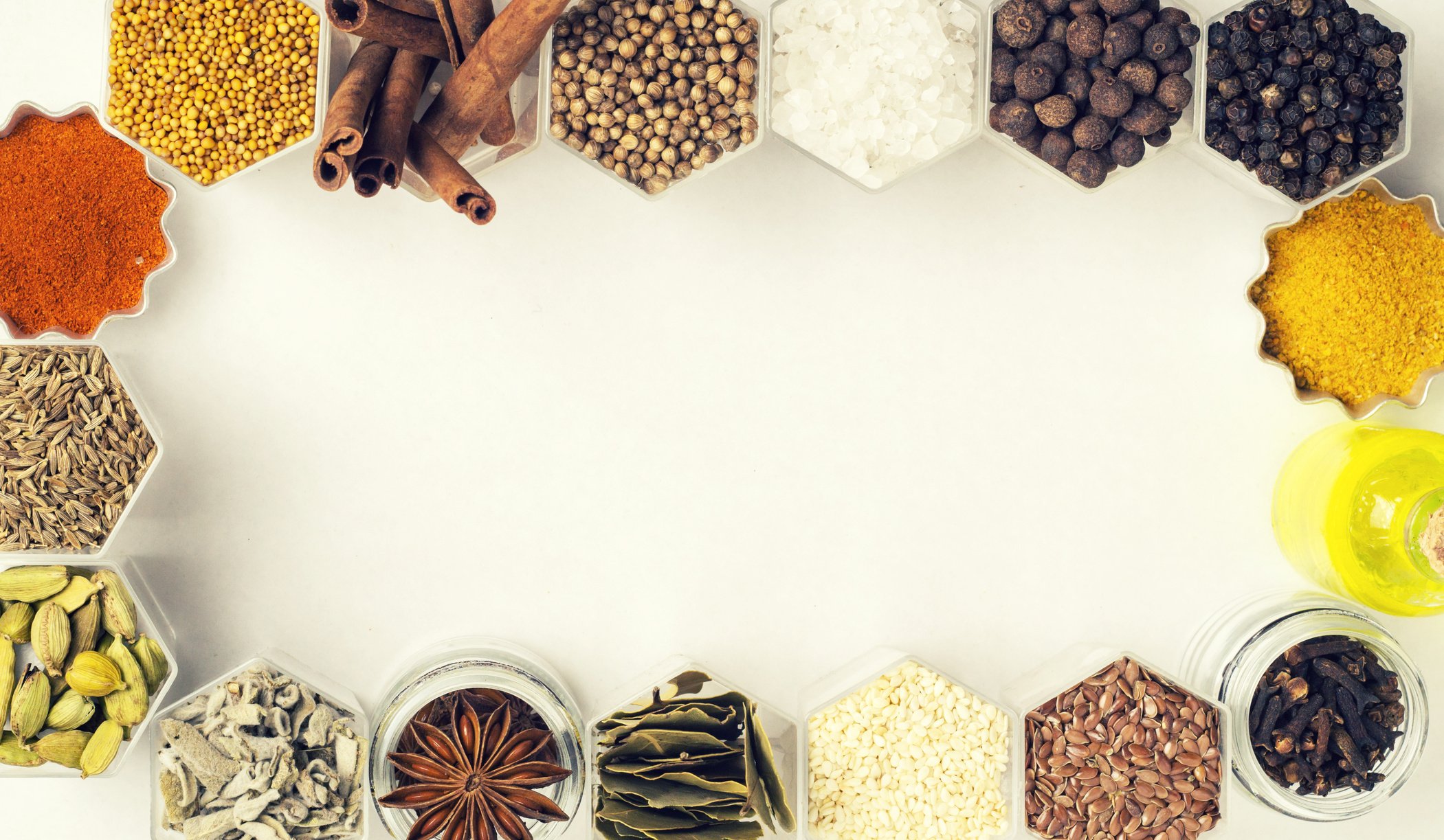 Spices in Hexagonal Jars on a White Background