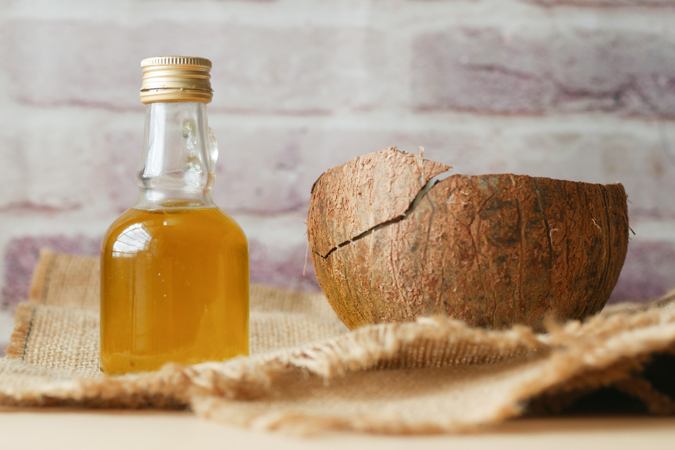 Little Bottle with Liquid and a Coconut Shell 